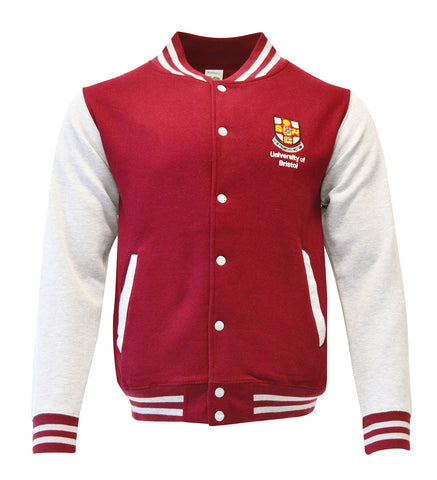 A baseball jacket which has a burgundy torso and white sleeves. There is burgundy and white stripes on the collar, cuffs and bottom of jacket. There are white buttons down the front and the crest of the University of Bristol over the left chest.