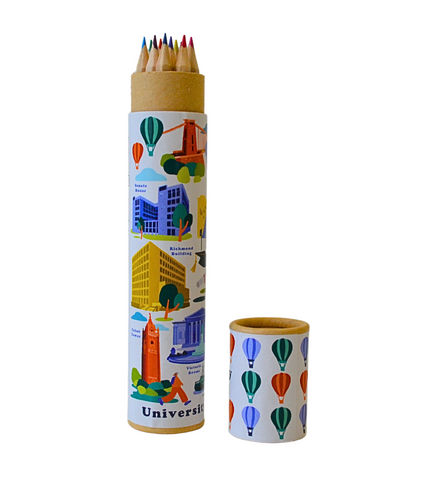 A cardboard tube with various Bristol and University of Bristol landmarks on it including Cabot Tower, the Richmond Building and Clifton Suspension Bridge. The tips of the colouring pencils are seen at the top of the tube. The lid has hot air balloons on. 