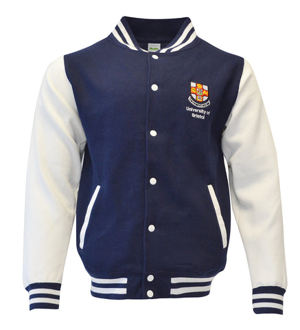 A baseball jacket which has a navy torso and white sleeves. There is navy and white stripes on the collar, cuffs and bottom of jacket. There are white buttons down the front and the crest of the University of Bristol over the left chest.