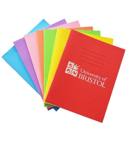 A pile of exercise books displayed as a fan. The exercise books are different colours, blue, purple, pink, orange, green, yellow, red. On the front of the top exercise book there are four thin black lines and below this the logo of the University of Bristol and the words "University of Bristol" printed in silver.
