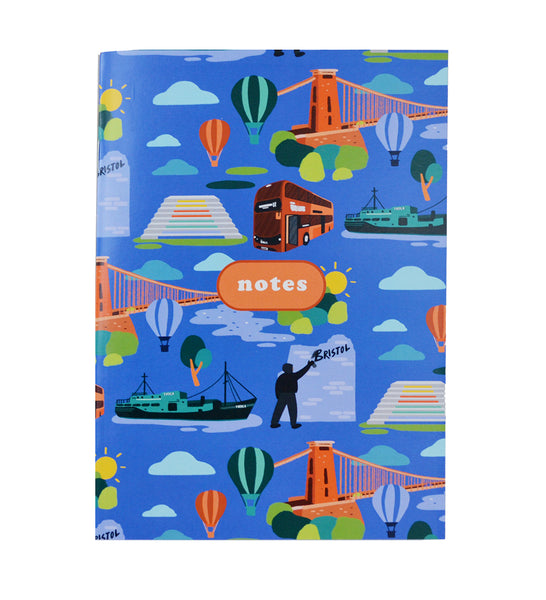 The front of a notebook. There is a text box in the centre of the notebook, with the word "notes" in bubble writing. Pictured on the notebook are Bristol and University of Bristol landmarks including Clifton Suspension Bridge, Thekla and Cantock Steps. The background of the notebook is blue in colour.