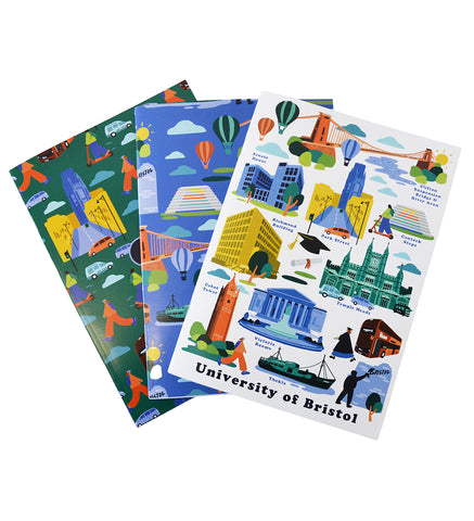 Three notebooks arranged in a fan. One with a green background, one with a blue background and one with a white background. All feature images of various Bristol and University of Bristol landmarks including Clifton Suspension Bridge, The Richmond Building, Cabot Tower and Park Street.